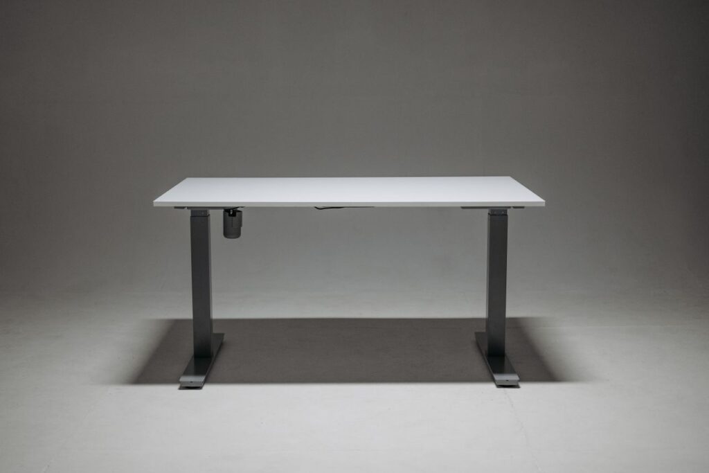 Sleek adjustable height standing desk with a single motor for ergonomic office solutions.